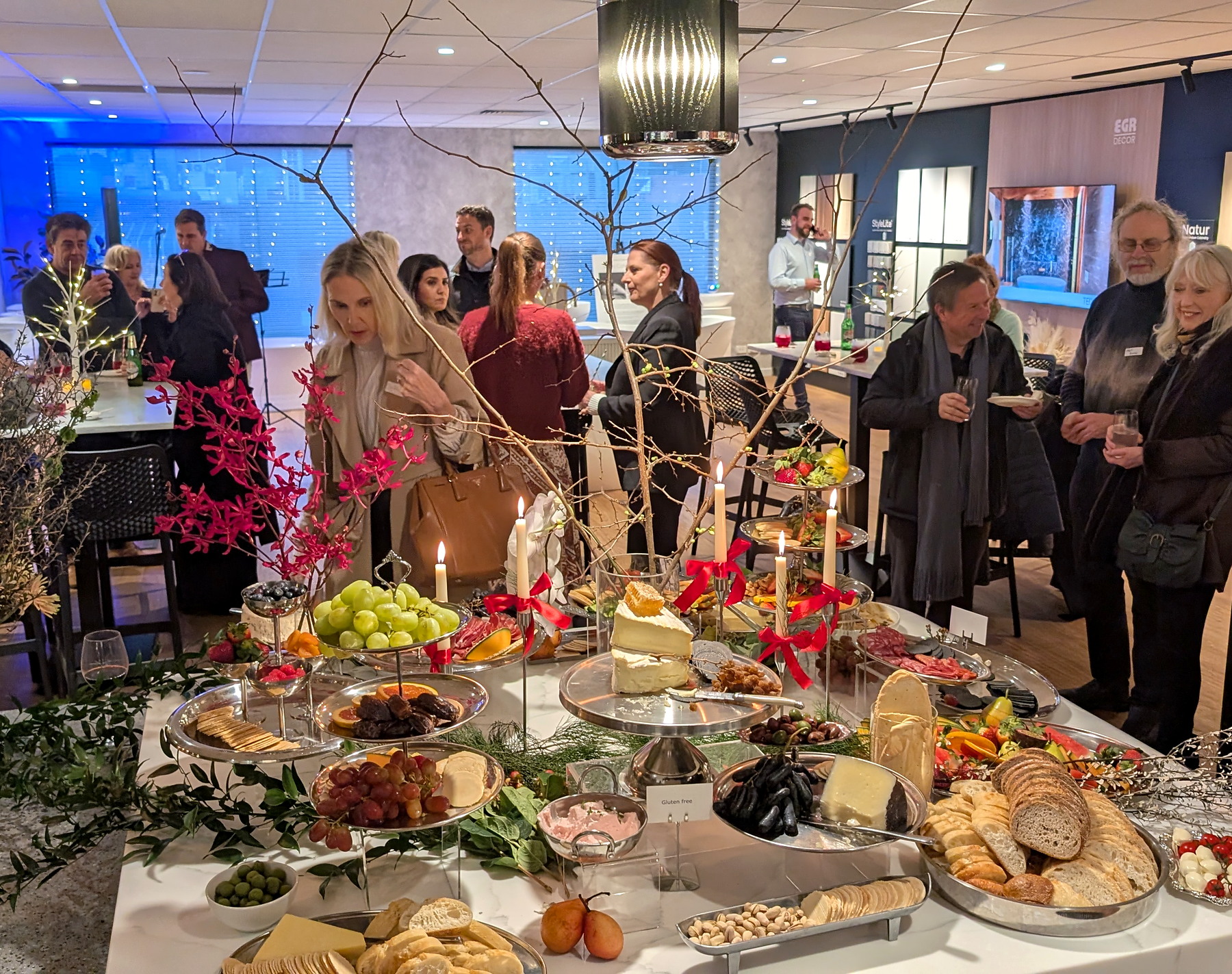 Guests gathered around an everydayfood grazing table at a Lux by Design corporate event