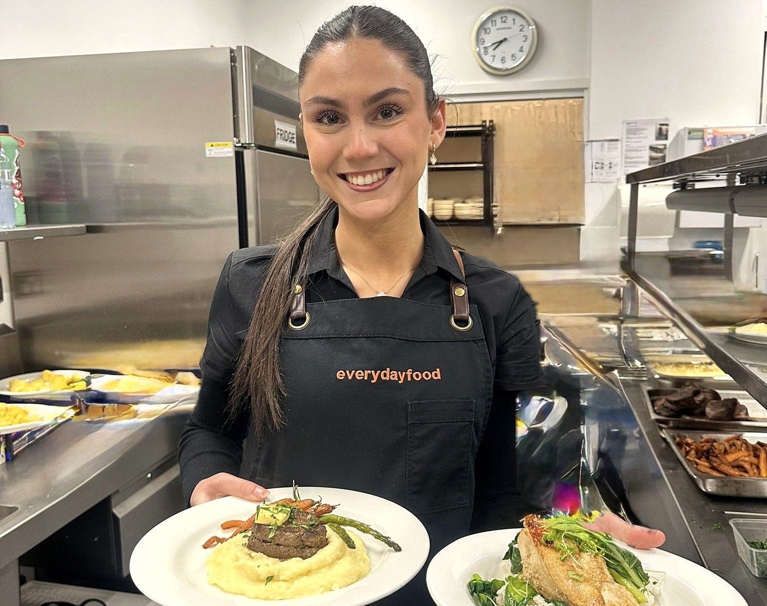 An everydayfood team member presenting plated event dishes