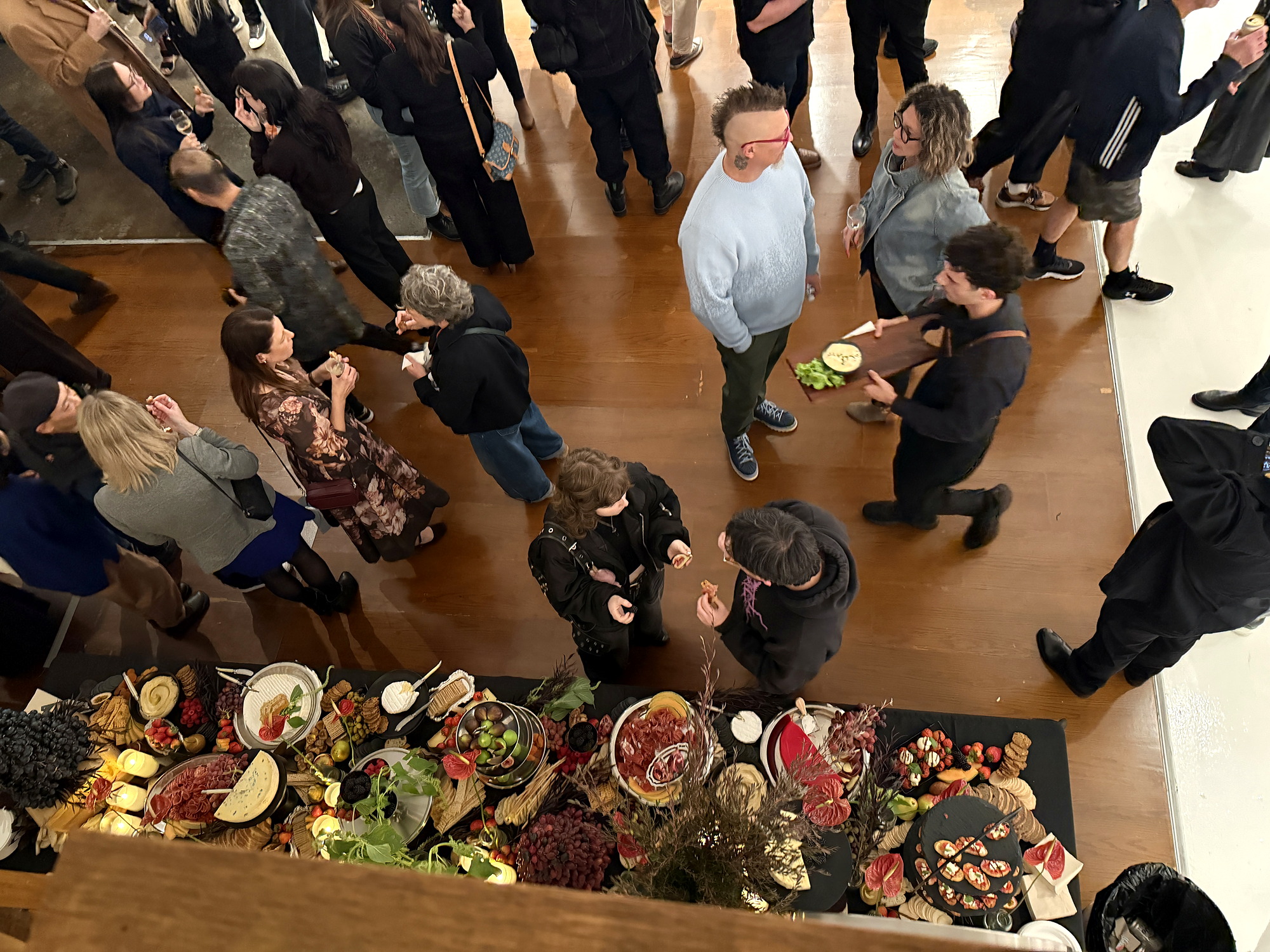 Guests gathered around an abundant everydayfood grazing table at a Melbourne event