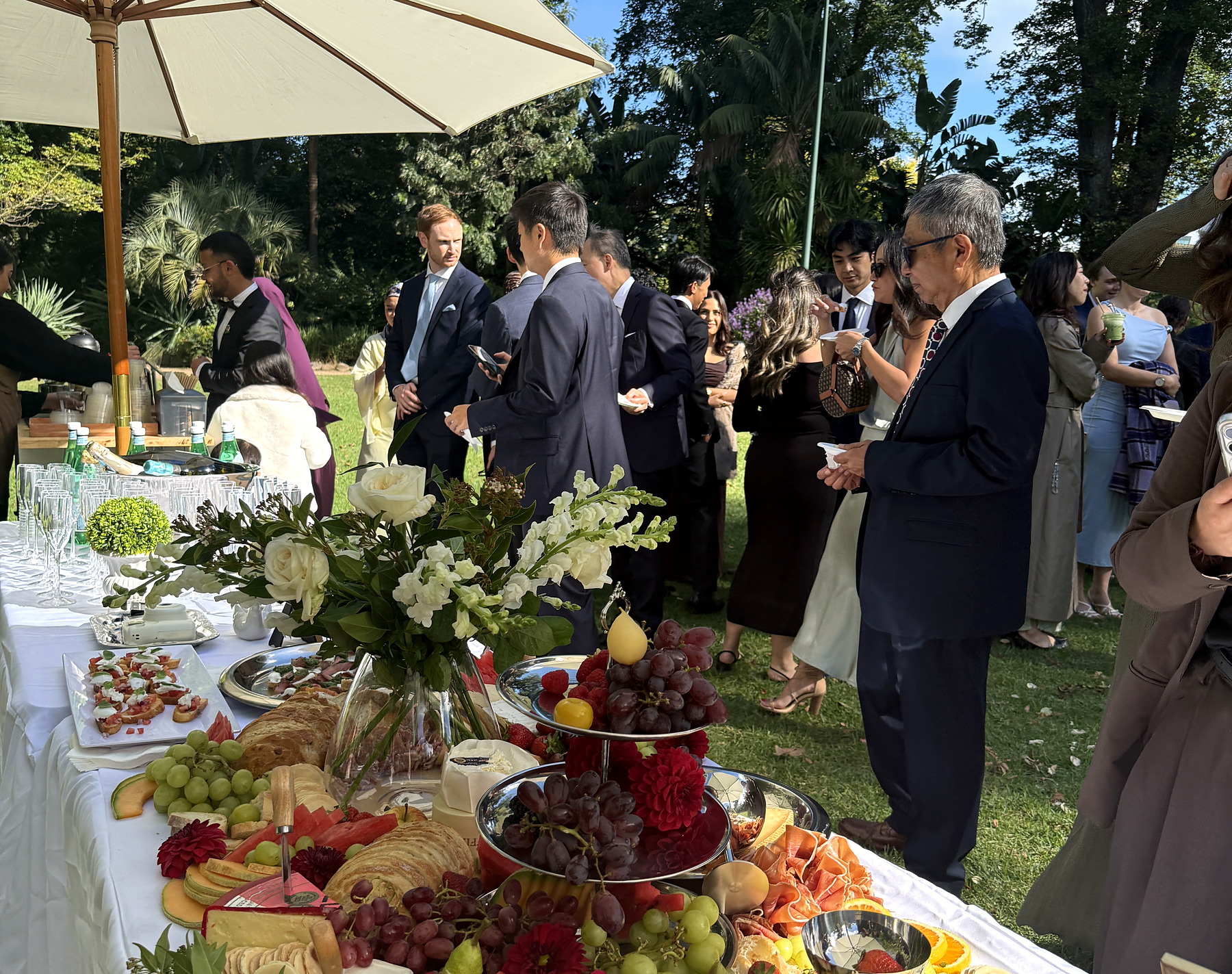Wedding guests gathered beside an everydayfood grazing table