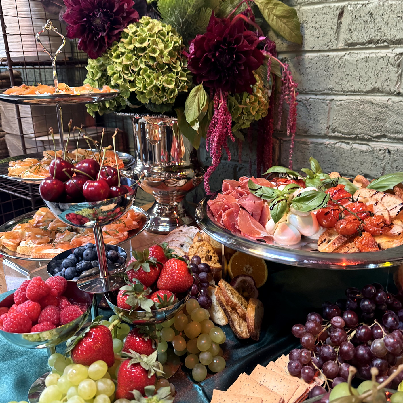 An abundant everydayfood grazing presentation with premium produce and silver serving pieces