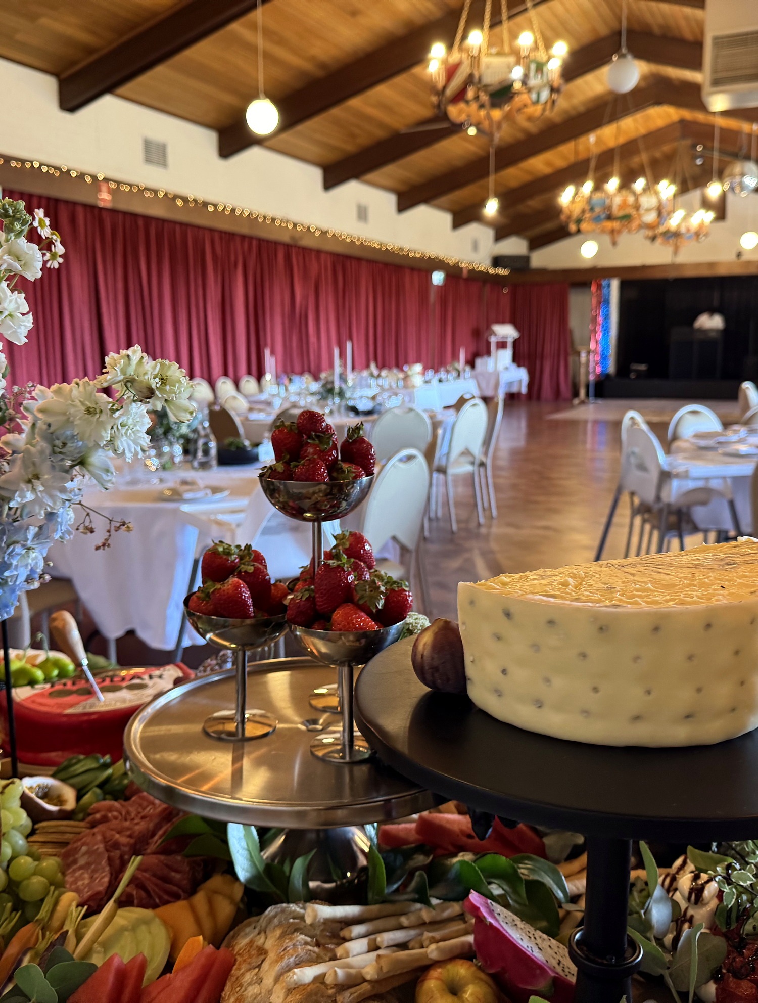 A styled everydayfood grazing table with a feature cheese wheel