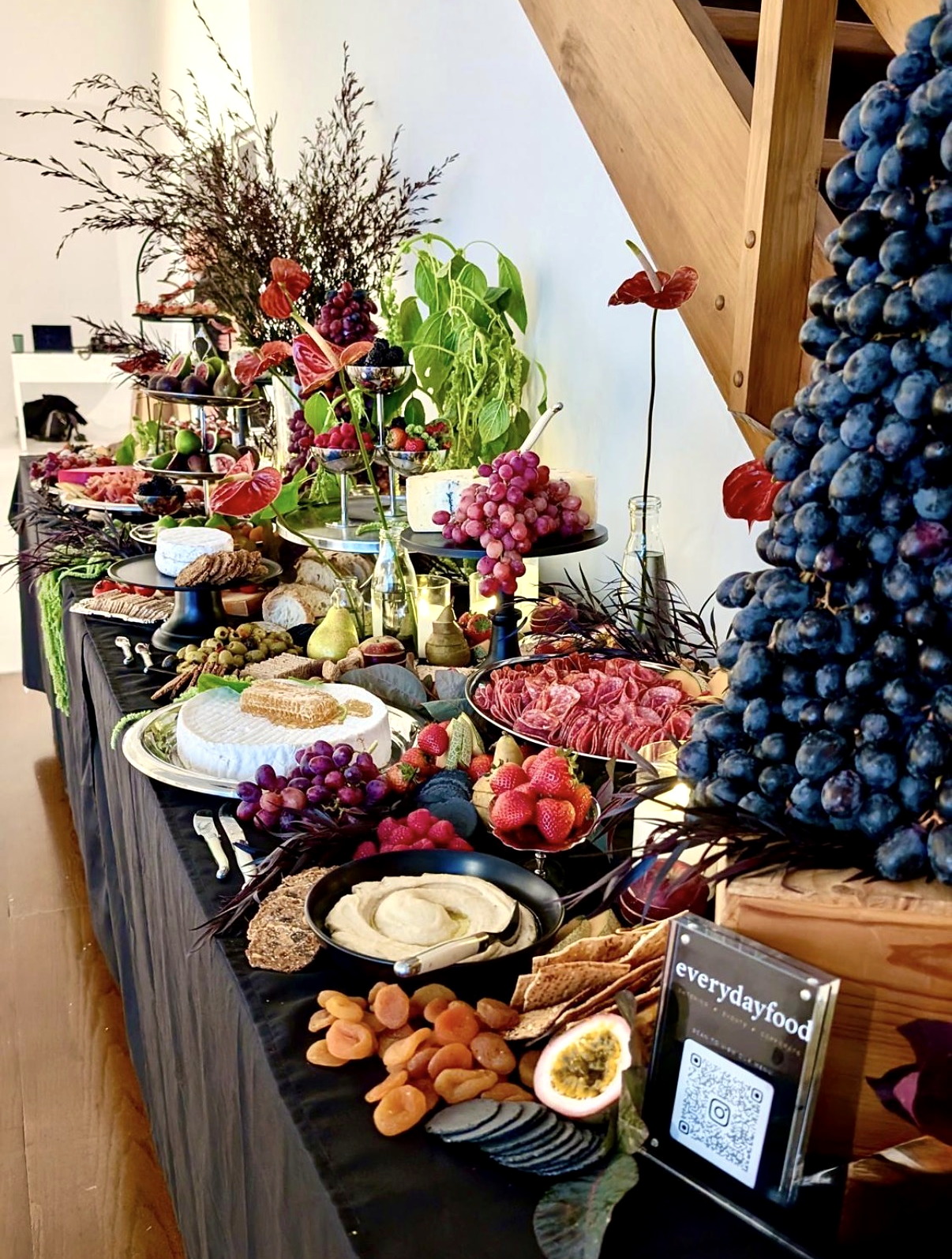 A generous everydayfood grazing table with a grape feature