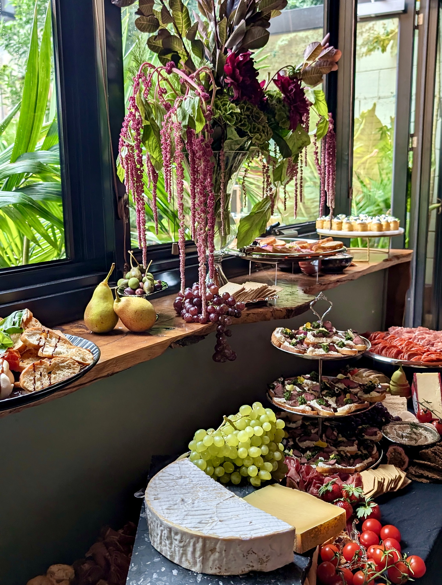 A styled everydayfood grazing table beside large windows