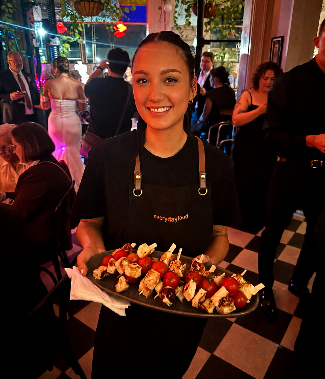 An everydayfood team member presenting a tray of canapes