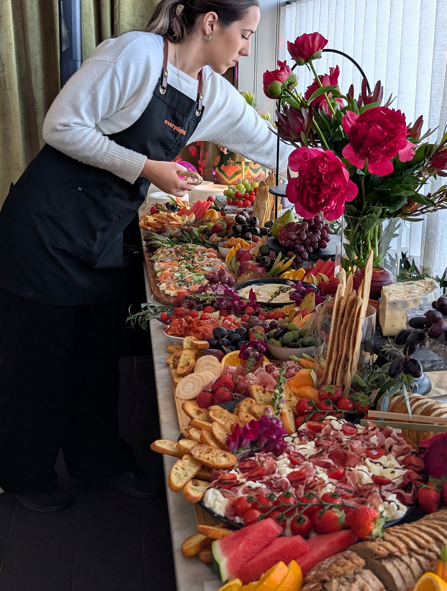 An everydayfood team member styling an abundant grazing table