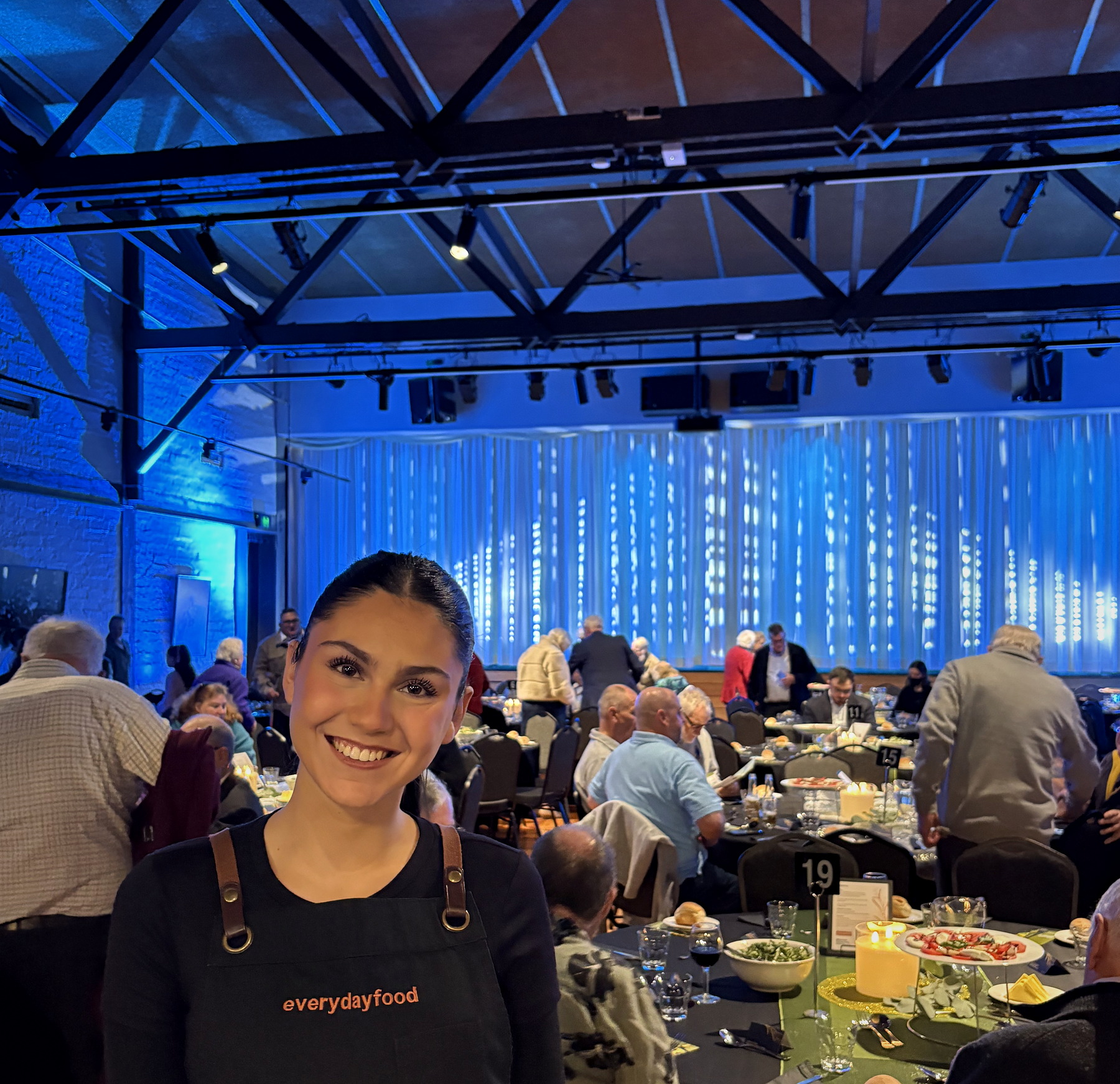 An everydayfood team member providing dining service at an event