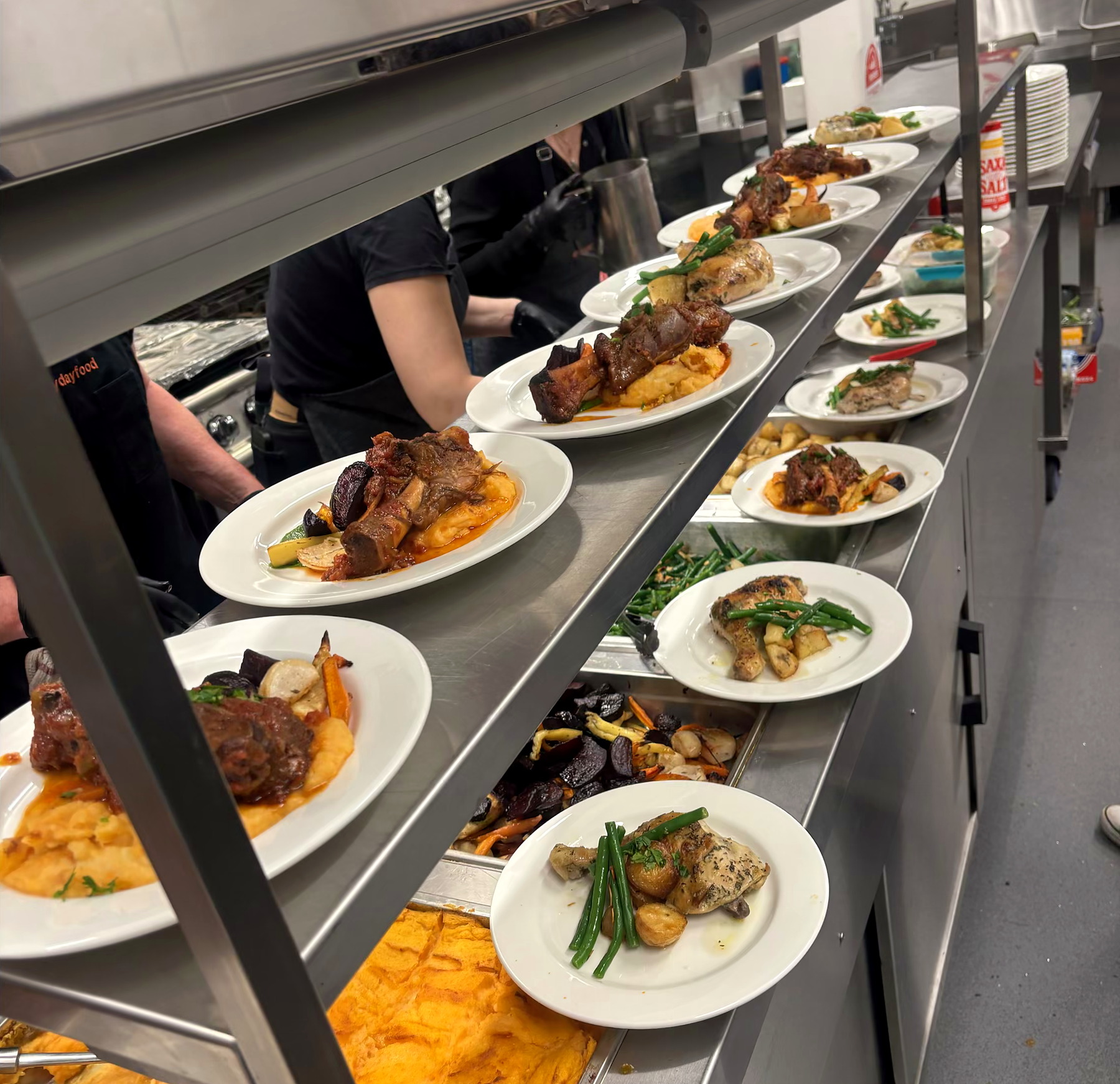 Plated seated dining prepared on the everydayfood kitchen pass