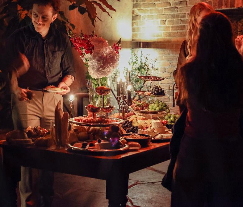 Guests enjoying finger food at a candlelit cocktail event