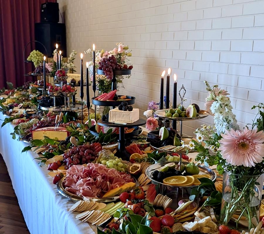 An abundant everydayfood grazing table prepared for wedding arrival