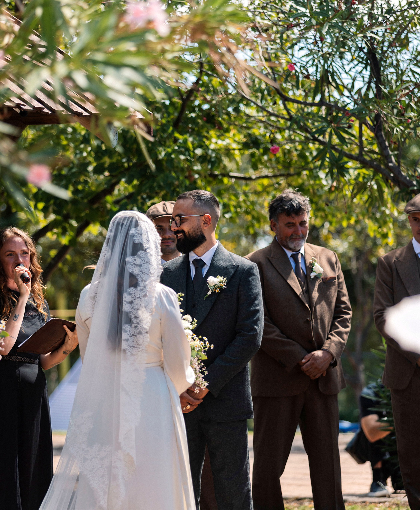 A bride and groom during their outdoor wedding ceremony