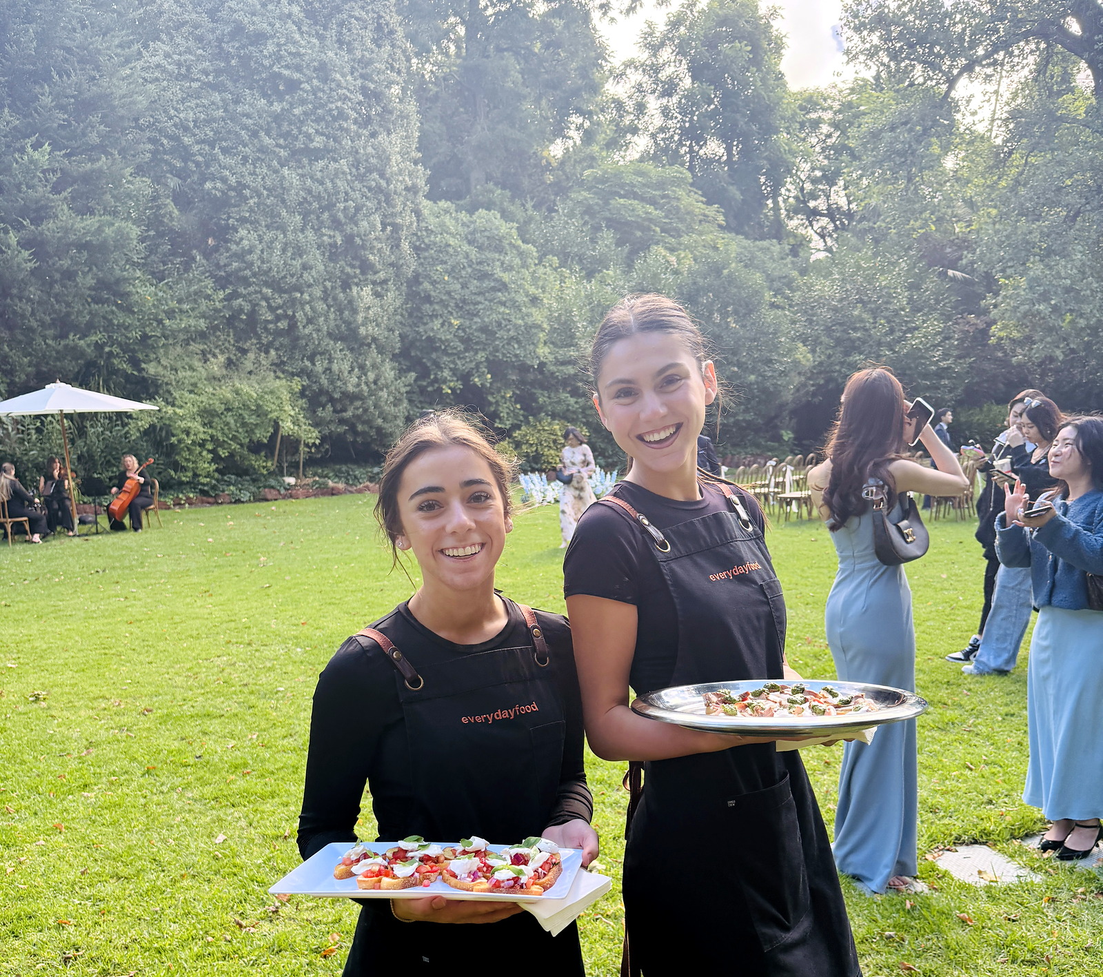 Everydayfood staff serving canapes at an outdoor wedding